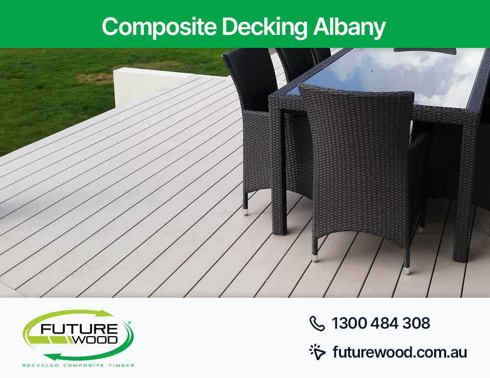 Picture of a deck made of composite decking boards with chairs and a table in Albany
