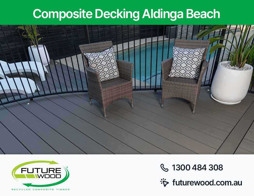 Image of a poolside view of two wicker chairs on a composite decking boards in Aldinga Beach
