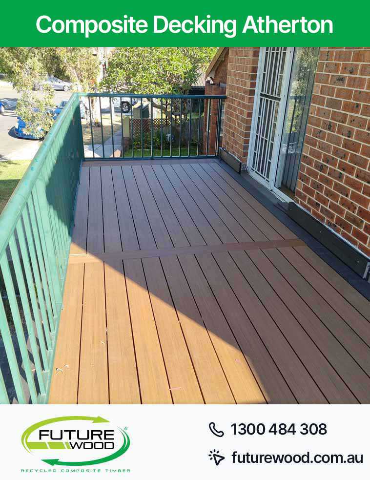 A deck made of composite decking boards in Atherton with a railing and green fence