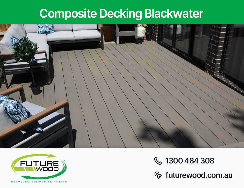 Image of modern patio in Blackwater with comfortable furniture on composite decking boards