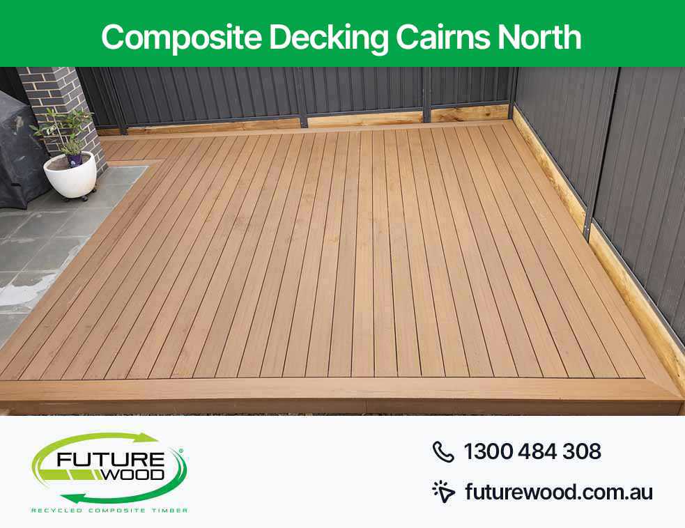 Image of composite deck boards on patio with black wall in Cairns