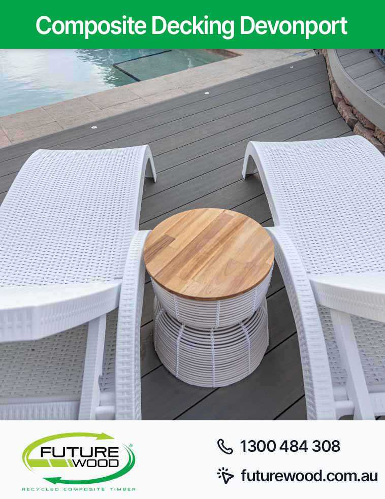 Photo of white lounge chairs on a composite deck boards next to a pool in Devonport