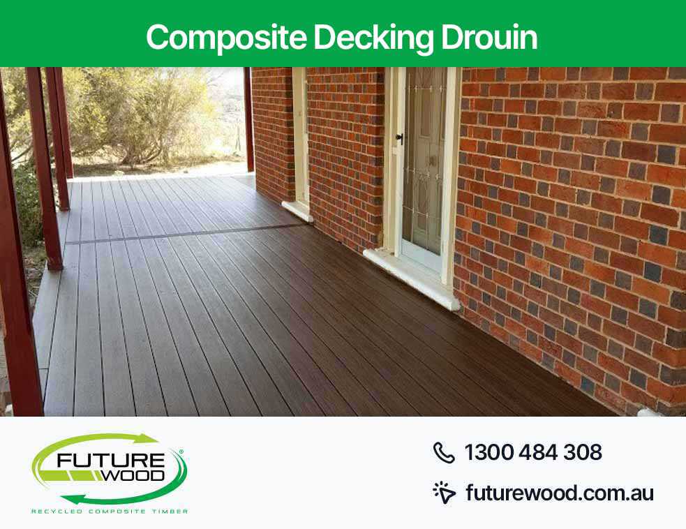 Picture of composite deck boards on a brick patio with a brick wall in Drouin