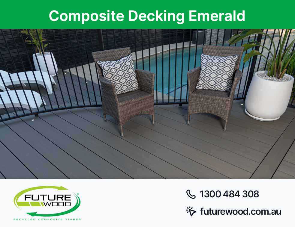Picture of wicker chairs on a composite deck boards, overlooking a pool in Emerald