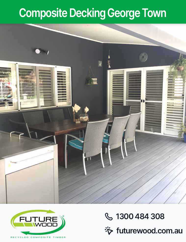 Picture of a composite deck boards featuring a table and chairs for outdoor relaxation in George Town