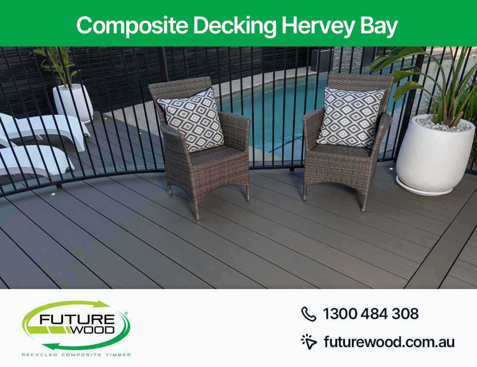 Picture of wicker chairs on a composite deck boards, overlooking a pool in Hervey Bay