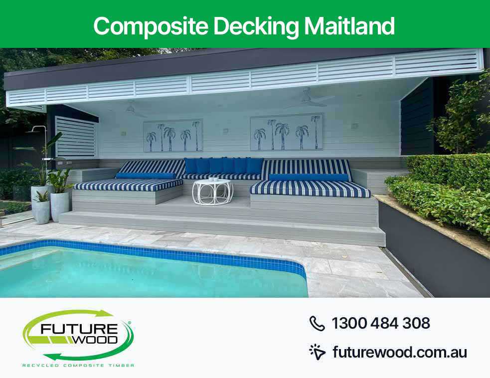 Blue and white cushions by a pool in Maitland, with composite decking boards as the backdrop