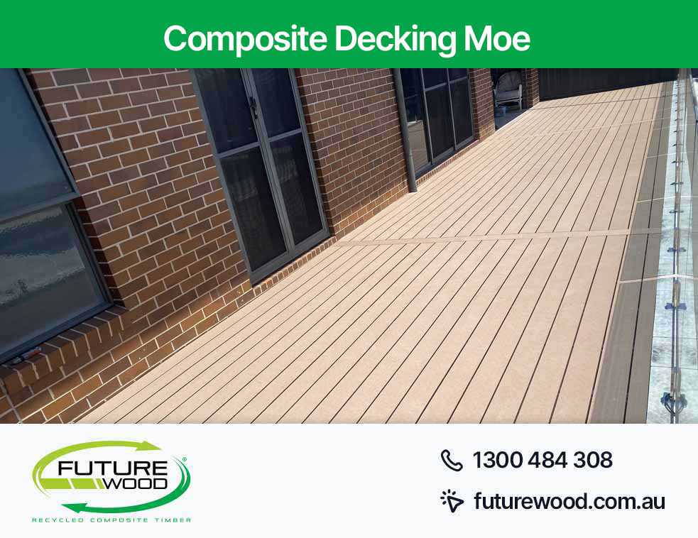 A visually appealing deck with two railings, highlighting the use of composite decking boards in Moe