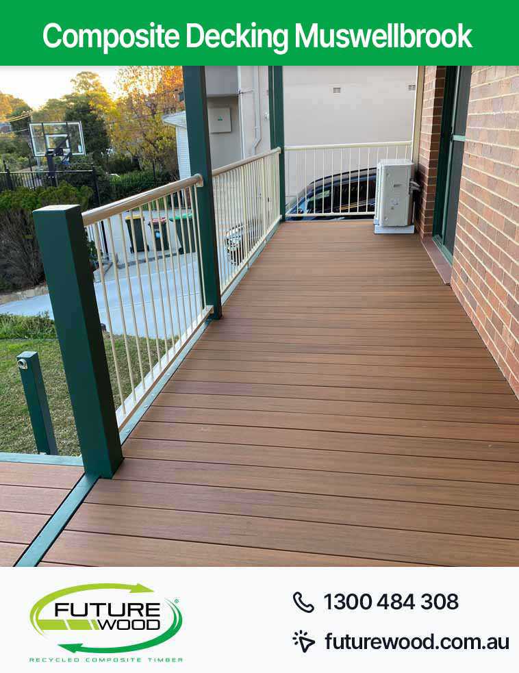 A deck made of composite decking boards in Muswellbrook, with a green fence