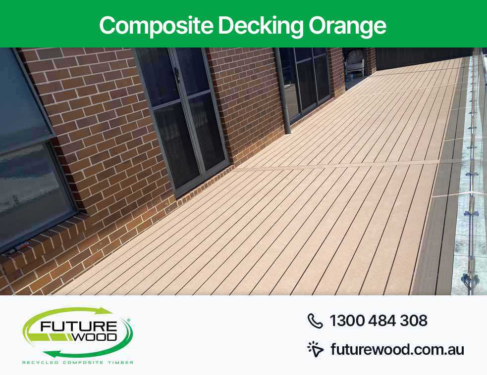 An image of composite decking boards with two sturdy railings in Orange