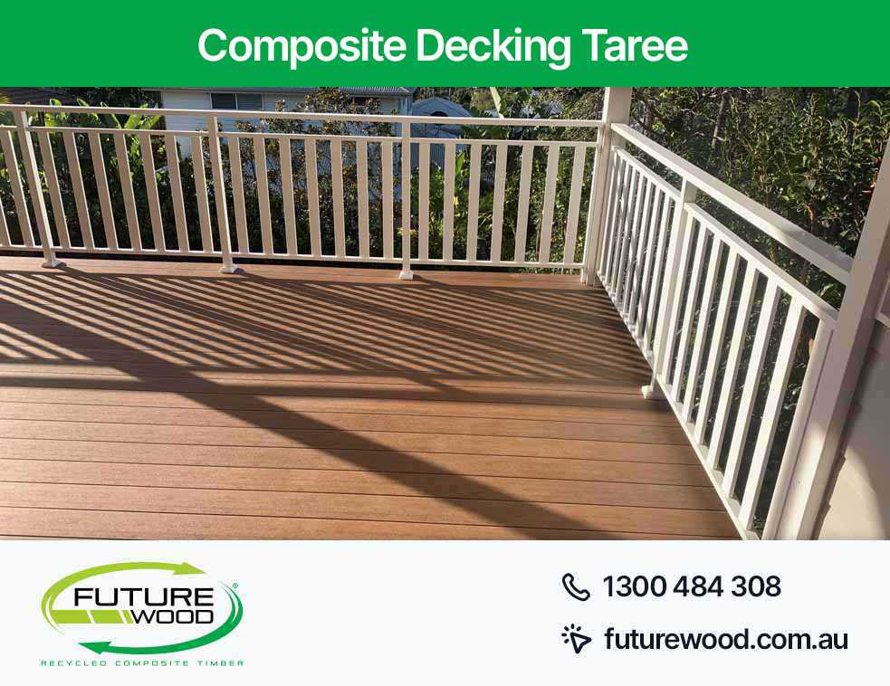 A deck in Taree made of composite deck boards featuring white railings