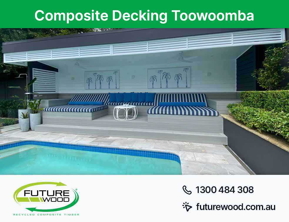 Blue and white cushions by a pool in Toowoomba, with composite decking boards as the backdrop