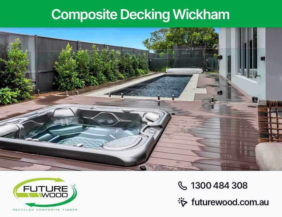 Picture of a luxurious hot tub and pool on a composite decking boards in Wickham