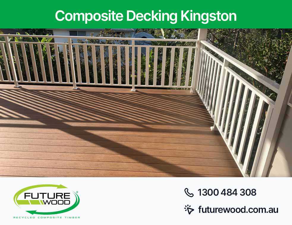 A deck in Kingston made of composite deck boards featuring white railings