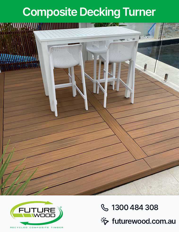A deck with white chairs and a table, made of composite decking boards in Turner