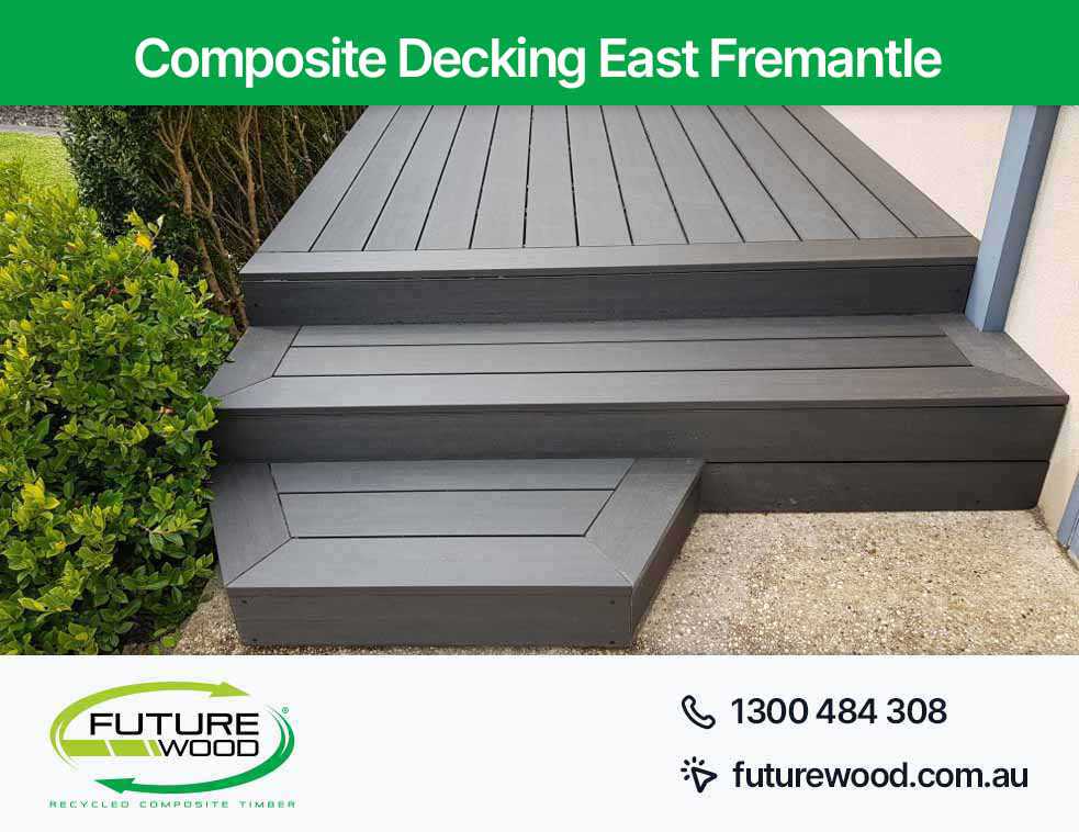 Black decking boards with steps made of composite material in East Fremantle