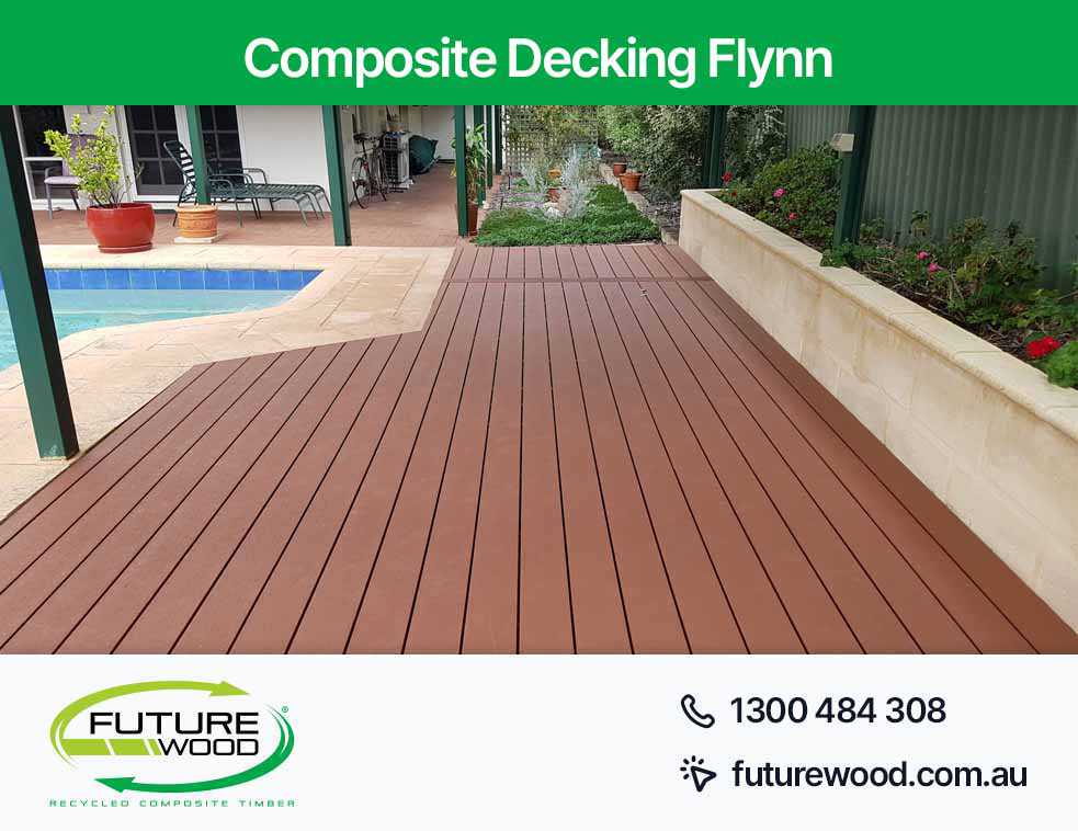 A composite deck boards, featuring a pool and patio in Flynn