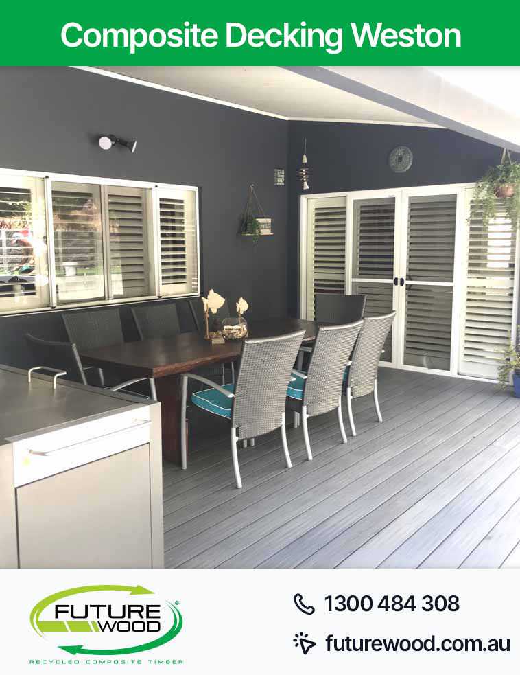 Relaxing on a deck in Weston made of composite decking boards with a table and chairs